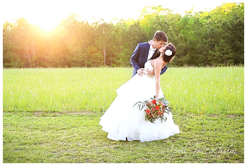 Bride and Groom in a field at Sunset